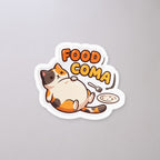 Food Coma Cat Sticker on a concrete floor