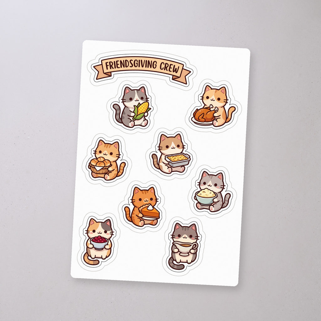 Friendsgiving Cat Crew Sticker Sheet, sticker sheet on a concrete floor