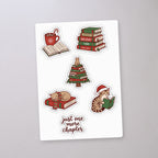 Holiday Reading Cat Sticker Sheet, sticker sheet on a concrete floor