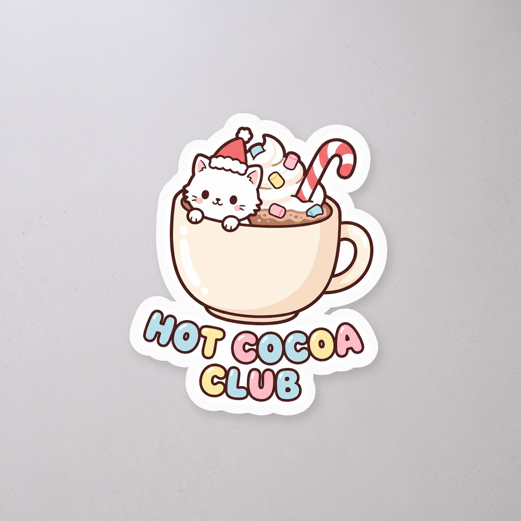 Hot Cocoa Club Cat Sticker on a concrete floor