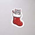 Kitten in a Stocking Sticker on a concrete floor