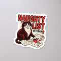 Naughty List Veteran Cat Sticker on a concrete floor