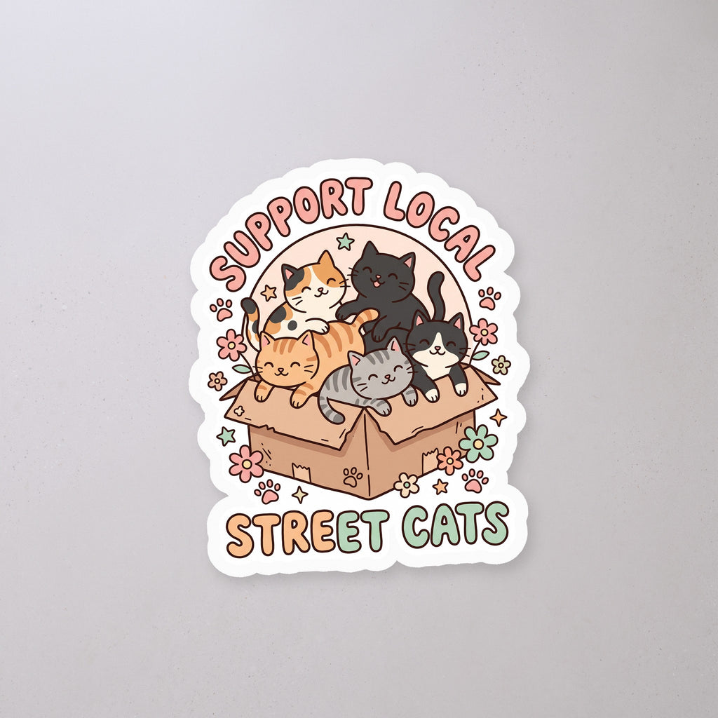 Support Local Street Cats Box Crew Sticker on a concrete floor