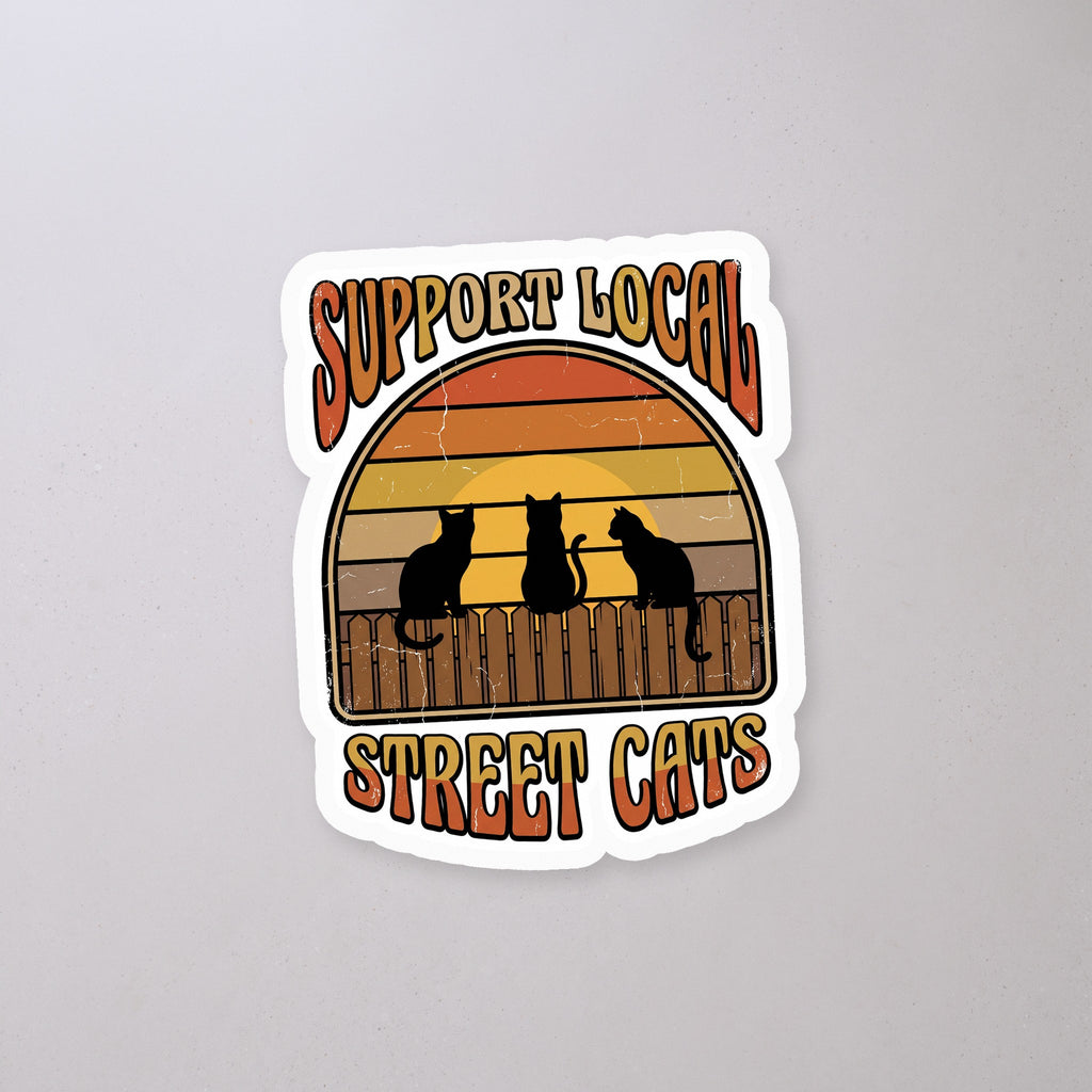 Support Local Street Cats Retro Sunset Sticker on a concrete floor